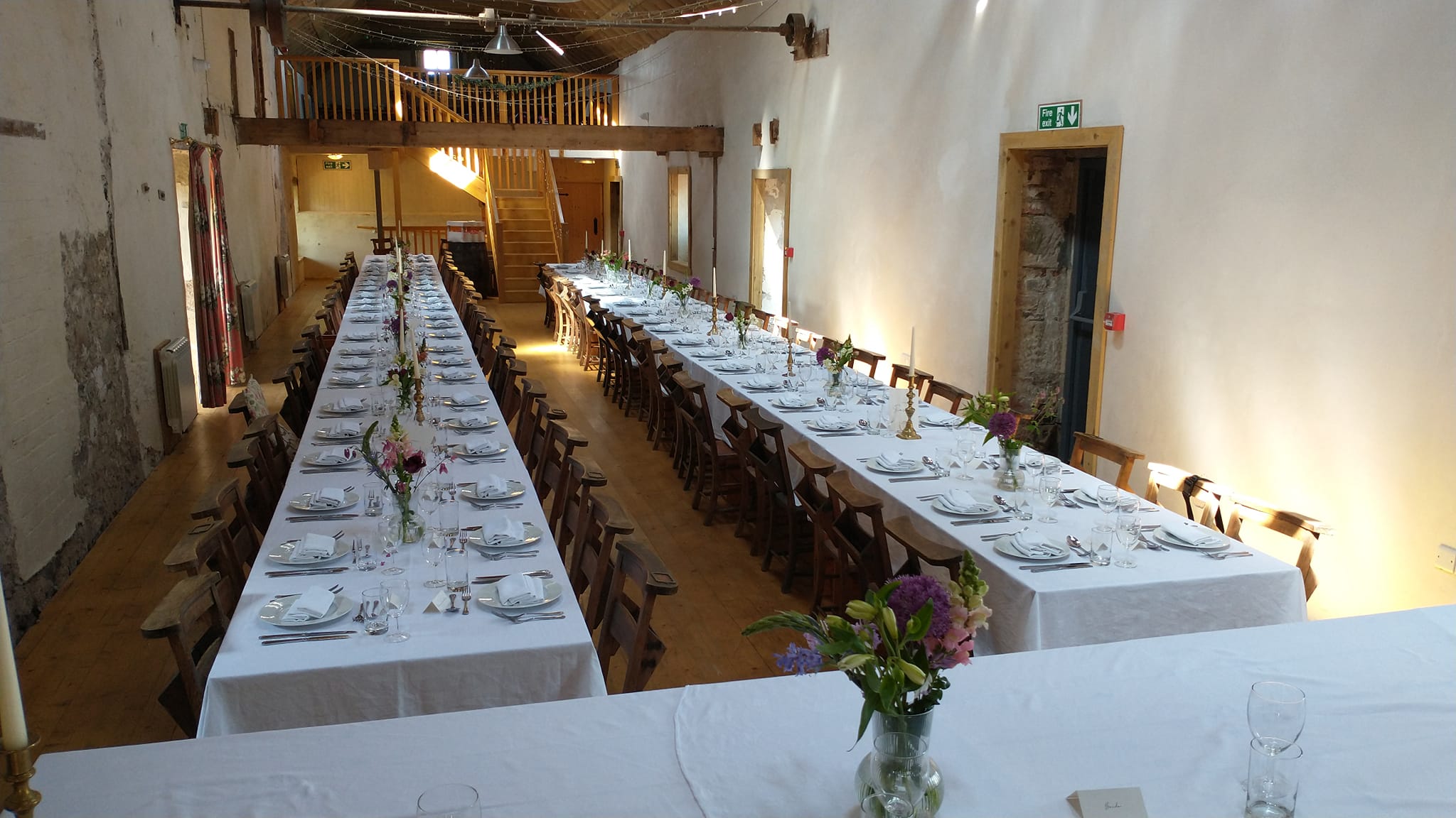 The Barn - long tables laid for reception